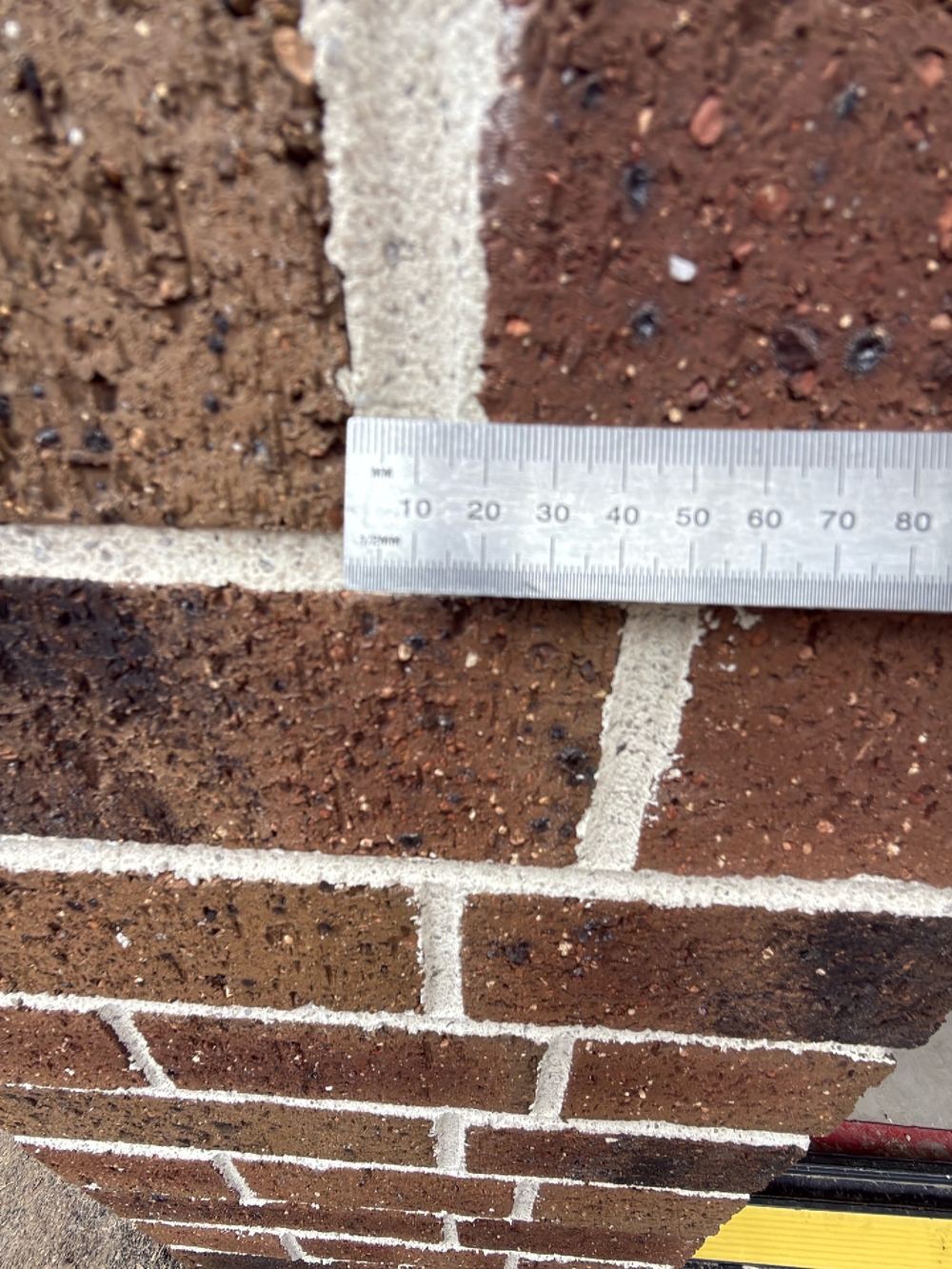 Vertical mortar joints wandering beyond acceptable limits across the wall, found during a defect investigation inspection in Reservoir