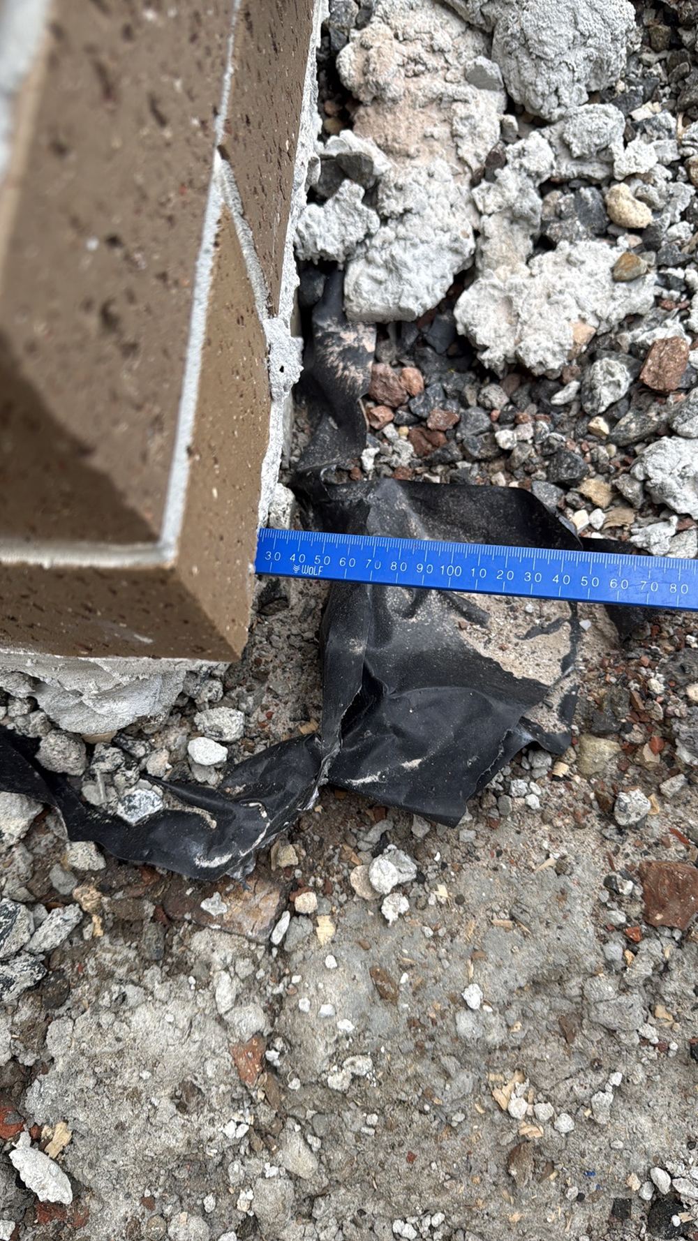 Bottom brick course projecting past the slab edge by more than 15mm, found during a lock-up inspection in Kalkallo