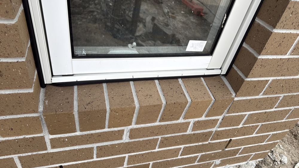 Window rubber flashing not sitting properly between the frame and brickwork, Kalkallo
